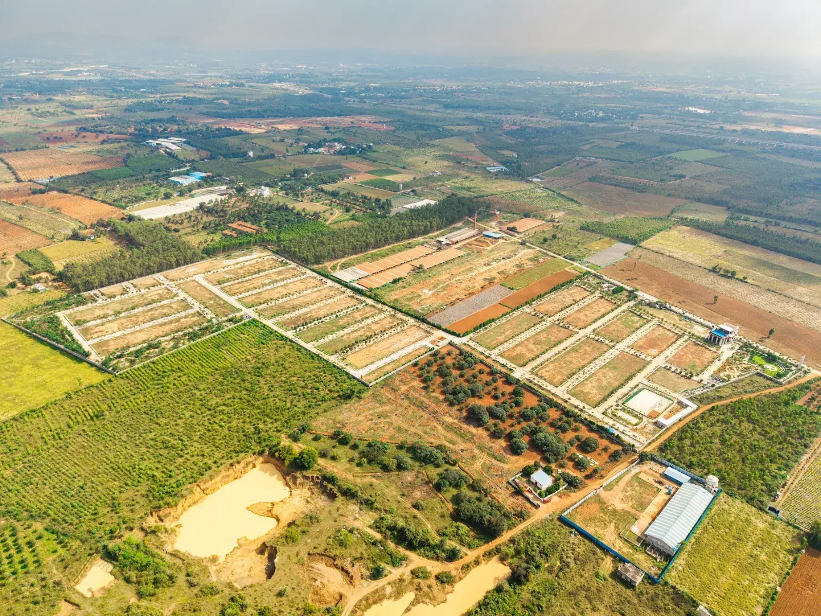 Drone view of the completed Aura Ville layout and the countryside around it